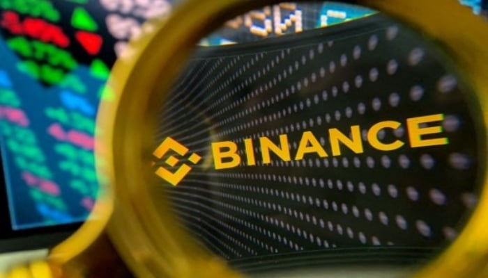 This representational picture shows the Binance logo through a magnifying glass. — AFP/File