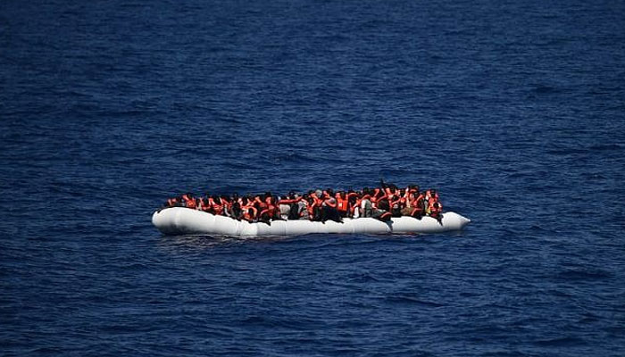 This file photo taken on May 24, 2016 shows African refugees waiting on a rubber boat to be rescued during an operation at sea, on May 24, 2016. — AFP
