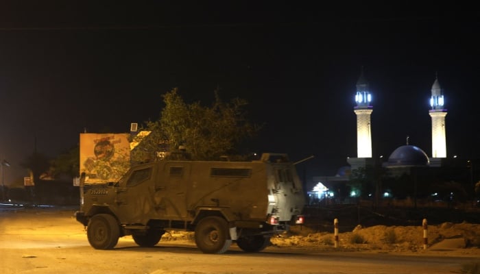 Israeli forces armoured vehicles storm the Aqabet Jaber refugee camp near Jericho in the occupied West Bank in the early hours of May 25, 2023. — AFP