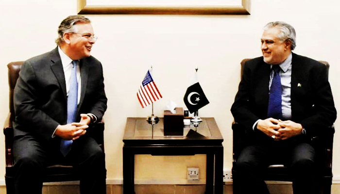 Minister for Finance and Revenue Senator Ishaq Dar (right) speaks to US Ambassador Pakistan Donald Blome in Islamabad, on June 21, 2023. — Twitter/@FinMinistryPak
