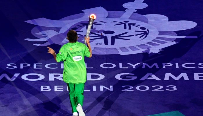 An athlete from Pakistan runs with the flame around the stadium during the opening ceremony of the Special Olympics World Games at the Olympic Stadium in Berlin on June 17, 2023. — AFP