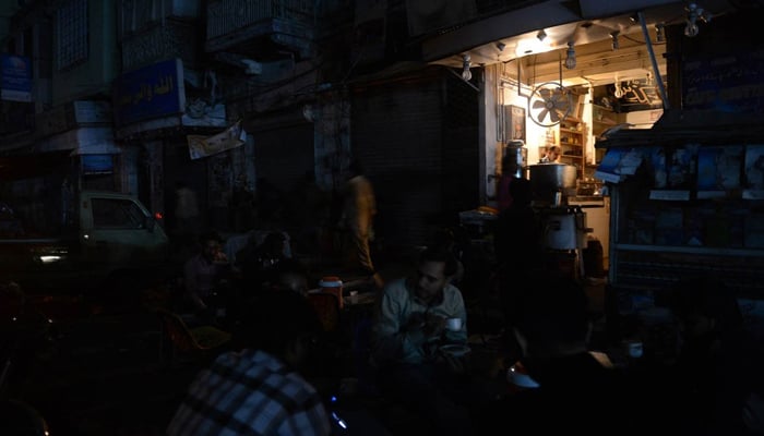 People at a hotel during a power outage. — AFP/File