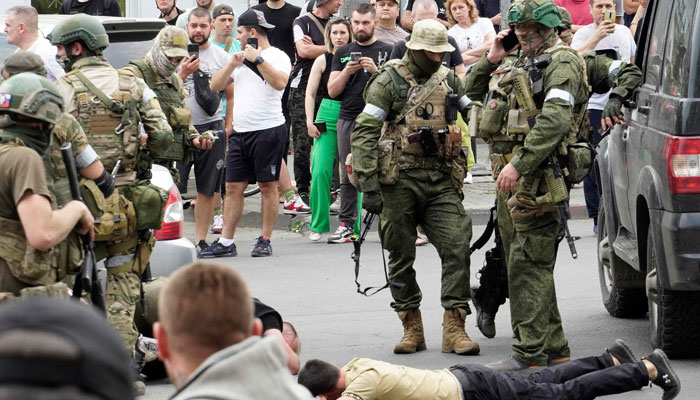 Members of the Wagner group detain a man in the city of Rostov-on-Don, on June 24, 2023. — AFP