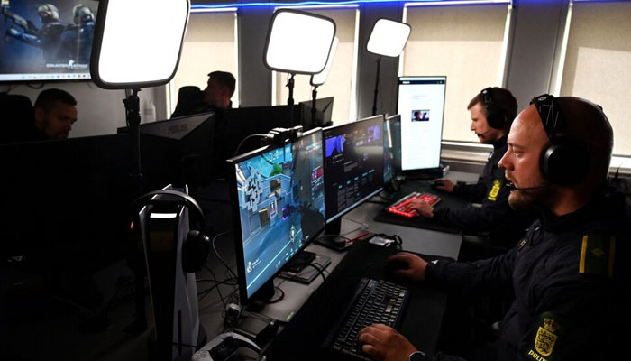 This picture shows police in Denmark playing computer games to target online abusers. — AFP/File