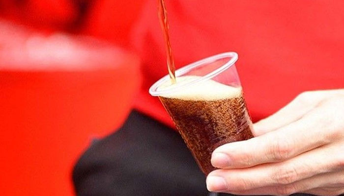 This representational picture shows an individual pouring soda on a cup. — AFP/File