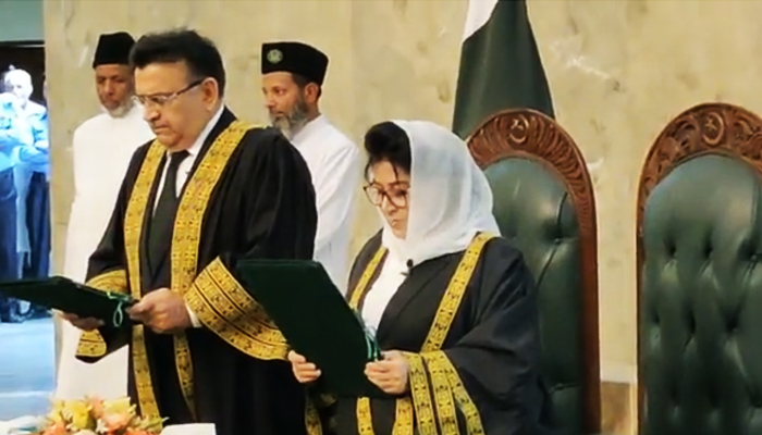 Chief Justice Umar Ata Bandial (left) administers the oath to Justice Mussarat Hilali, making her the second woman SC judge, in Islamabad, on July 7, 2023, in this still taken from a video. — Reporter