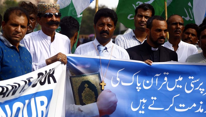 Activists of Jamat-e-Islami (JI) Minority Wing protesting against desecration of Holy Quran in Sweden, at Karachi press club on Thursday, July 6, 2023. — PPI