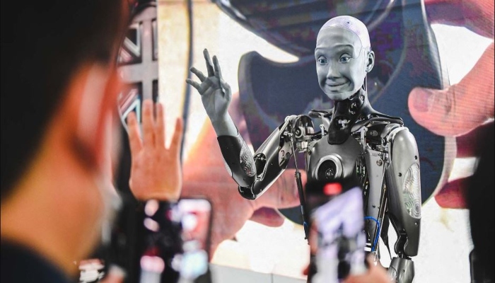This representational picture shows a human-like robot waving at viewers. — AFP/File