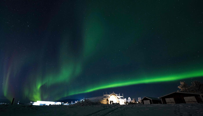 Northern lights (aurora borealis) illuminate the sky over Jukkasjarvi, near Kiruna, in Swedish Lapland, on November 20, 2022. — AFP