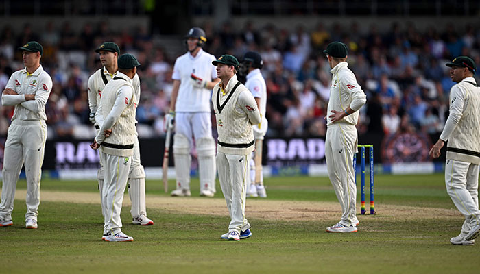 Australia´s players wait for a review that ruled in favour of England´s Ben Duckett on day three of the third Ashes cricket Test match between England and Australia at Headingley cricket ground in Leeds, northern England on July 8, 2023.—AFP