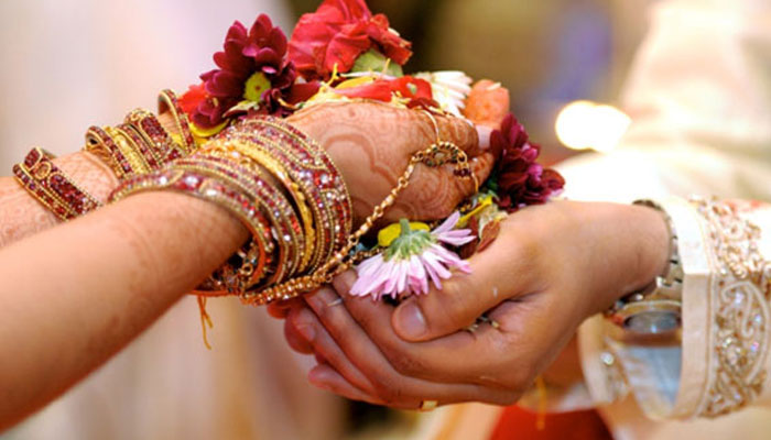 This representational picture shows an Indian bride and groom performing traditional marriage ritual. — AFP/File