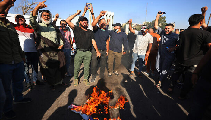 Supporters of Muslim leader Moqtada Sadr burn a rainbow flag outside the Swedish embassy in Baghdad, after they breached the building over the burning of the Holy Quran by an Iraqi living in Sweden, on June 29, 2023. — AFP