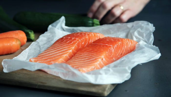 This representational picture shows two salmon fillets placed on a piece of paper. — Unsplash/File