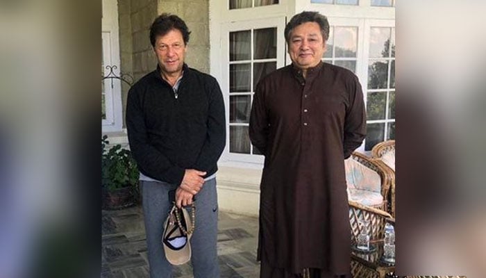 Former prime minister Imran Khan (left) and his then-principal secretary Azam Khan pose for a photo. — Facebook/Fanz of Azam Khan/File