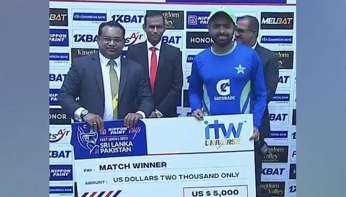 Pakistan skipper Babar Azam (right) receiving prize money after winning the first Test against Sri Lanka in Galle. — SLC