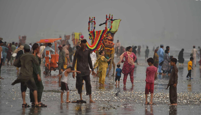 People enjoying pleasant weather at the Sea View beach in Karachi on July 20, 2023. — INP