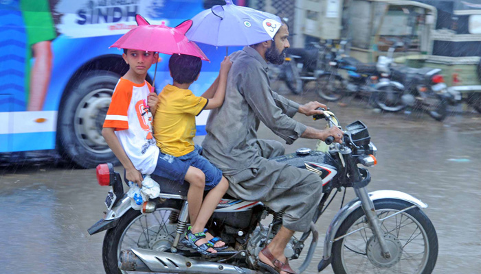 Motorists are on their way during heavy rainfall of moonsoon spell in Hyderabad on July 24, 2023. — Online