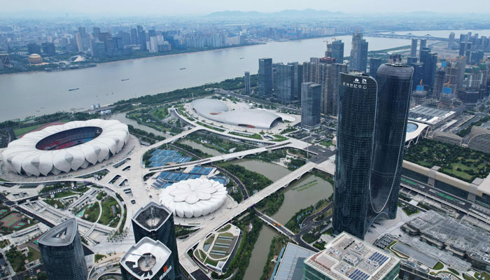 This photo taken on July 13, 2023 shows venues for competition at the Hangzhou Asian Games, at the Hangzhou Olympic Sports Center, in front of the Qiantang river in Hangzhou, in Chinas eastern Zhejiang province. — AFP