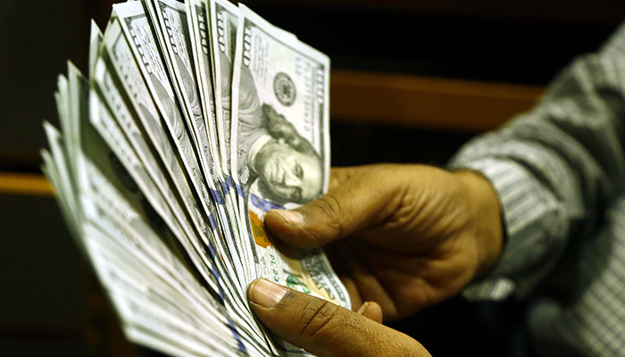Dollar import curbs on currency dealers lifted