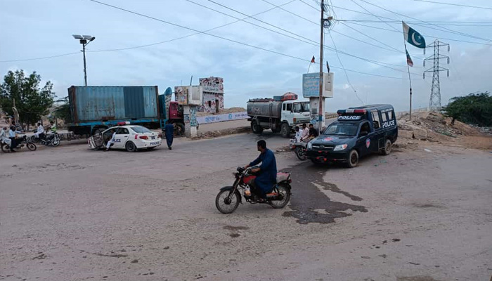 Heavy vehicles placed as barricades on the entry points of Korangi Causeway. — provided by reporter