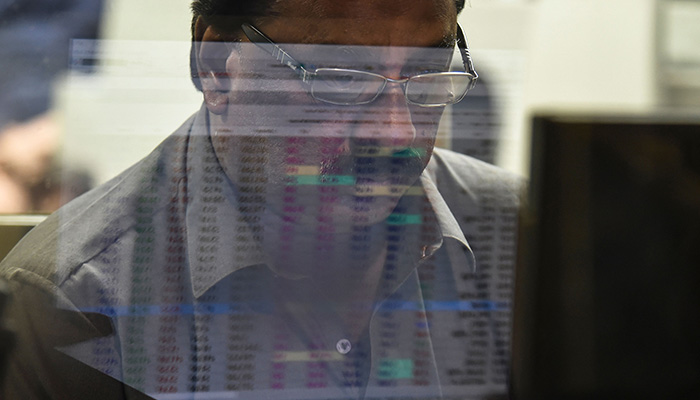 A stockbroker looks at the latest share prices at the Pakistan Stock Exchange (PSE) in Karachi on February 3, 2023. — AFP