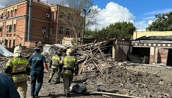 Locals walk past the explosion site with firefighters in Taganrog, Rostov region, Russia on 28 July, 2023. — Twitter/@DD_Geopolitics