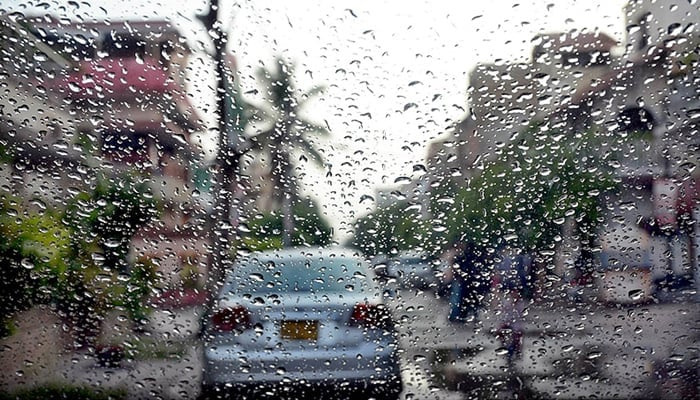 A car seen through a windscreen with raindrops. — APP/File