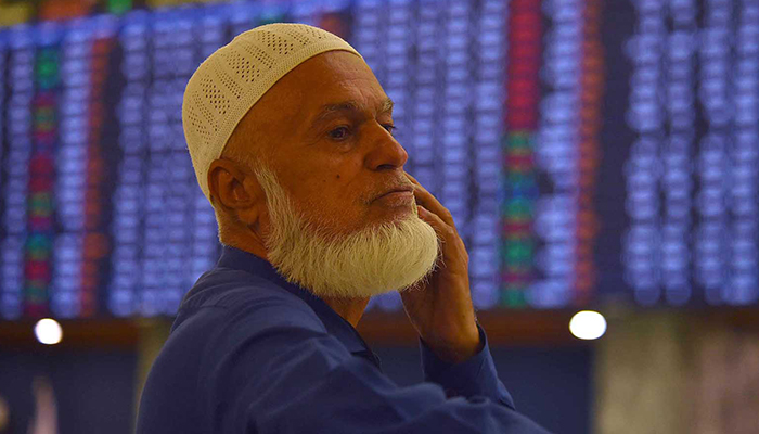 Pakistani stockbroker monitors the latest share price development during a trading session at the Pakistan Stock Exchange in Karachi, on March 13, 2023. — INP