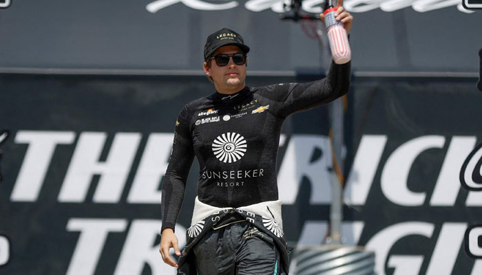 Noah Gragson waves to fans as he walks out during driver intros prior to the NASCAR Cup Series HighPoint.com 400 at Pocono Raceway on July 23, 2023, in Long Pond, Pennsylvania. — AFP