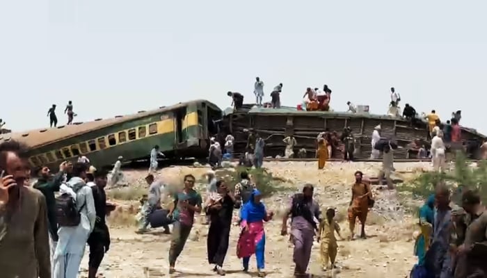 People busy in rescue efforts after a trail derailed at Sarhari Railway Station near Nawabshah, on August 6, 2023, in this still taken from a video. — Geo News