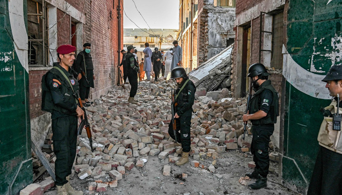 Security personnel inspect the site of a bomb blast in Bara province at Khyber Pakhtunkhwa district of Peshawar on July 20, 2023. — AFP