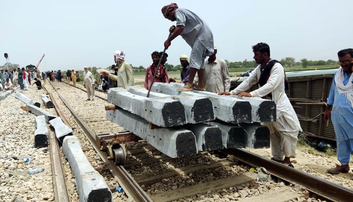 Labourers use heavy machinery to repair the mainstream track of Pakistan Railways on Monday, August 7, 2023. — PPI