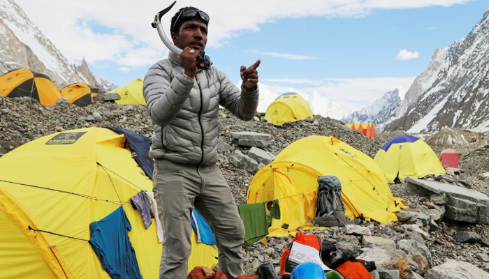 Sajid Ali Sadpara stands amid discarded tents, litter at the K2. — AFP/File