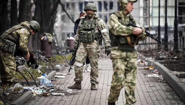 Russian soldiers walk along a street in Mariupol as troops intensify a campaign to take eastern and southern Ukraine. AFP