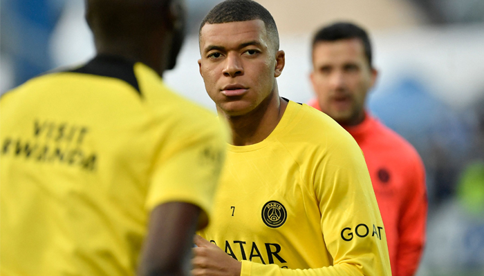 Paris Saint-Germains French forward Kylian Mbappe looks on as he warms up before the French L1 football match between AJ Auxerre and Paris Saint-Germain (PSG) at Stade de lAbbe-Deschamps in Auxerre, central France, on May 21, 2023. — AFP