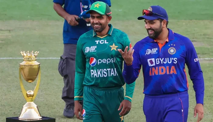 Babar Azam (left) and Rohit Sharma (right) walk in front of the Asia Cup trophy — AFP/File