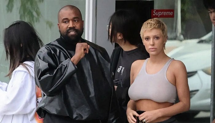 Kanye Wests unconventional fashion choices clash with summer heat, affecting marriage, sources claim.