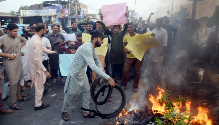 People protest at the Novelty Bridge in Faisalabad against the price hike of electricity and inflation across the country on August 25, 2023. — Online