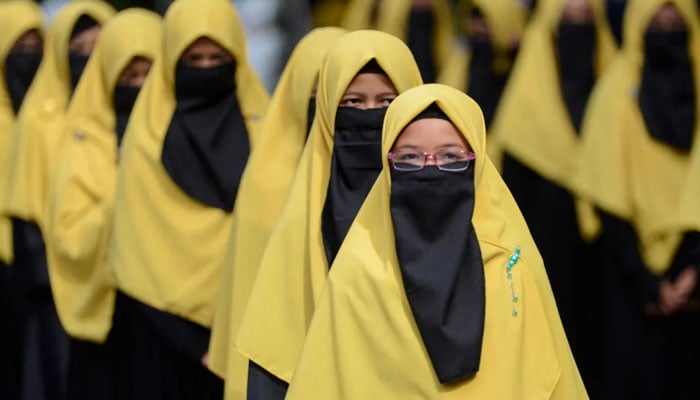A group of school girls during morning assembly at an Indonesian school. — AFP