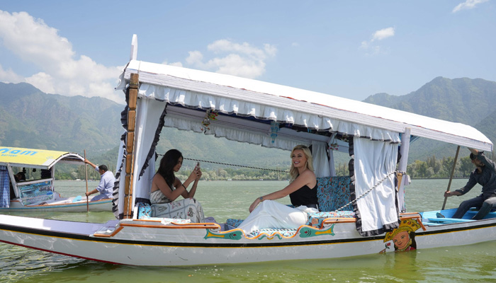 In this handout photo taken and released by the Jammu and Kashmir Tourism Department on August 29, 2023, Miss World 2022 Karolina Bielawska (C) and Miss India World 2022 Sini Shetty (L) ride a boat in the Dal lake in Srinagar, the summer capital of Jammu and Kashmir. — AFP