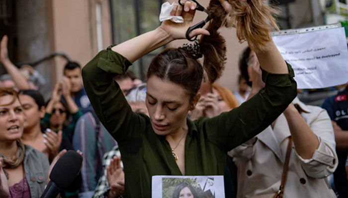 Girls and women protest against compulsory hijab law in Iran showing support for Mahsa Amini. — AFP