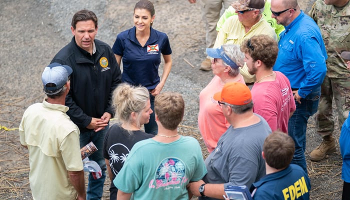 Florida Governor Ron DeSantis, second from left, talks with local business owners before a press conference in the aftermath of Hurricane Idalia on August 31, 2023, in Steinhatchee, Florida. — AFP