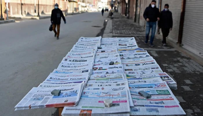 Local newspapers are placed on a newsstand along a road in Srinagar on January 29, 2022. — AFP