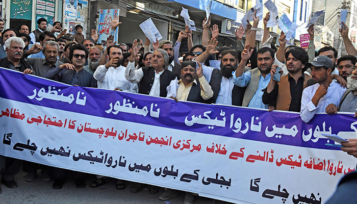 Traders shout slogans as they hold their electricity bills during a protest against the surge in petrol and electricity prices in front of the Quetta Press Club in Quetta on August 29, 2023. — AFP