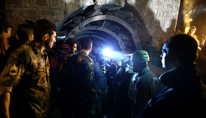 Coal miners and rescue workers seen at a mine in Azadshahr, in northern Iran, following an explosion in 2017. — AFP/File