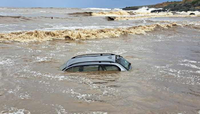 This picture taken on September 5, 2023, shows A car washed in the sea at Arapia camping near Tsarevo on the Bulgarian Black Sea coast after heavy rains led to flooding. — AFP