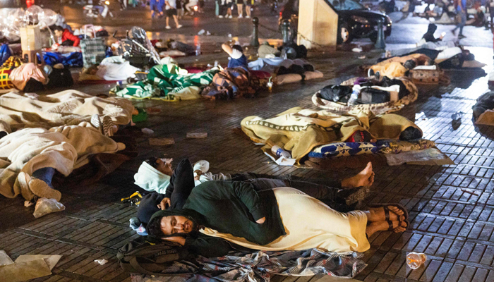Residents take shelter outside at a square following an earthquake in Marrakesh on September 9, 2023. — AFP
