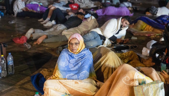 Residents take shelter outside at a square following an earthquake in Marrakesh on September 9, 2023. — AFP