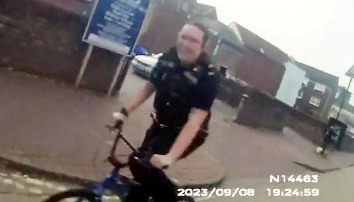 Hampshire police officer Harriett Taylor riding a kids bike. — Gosport Police