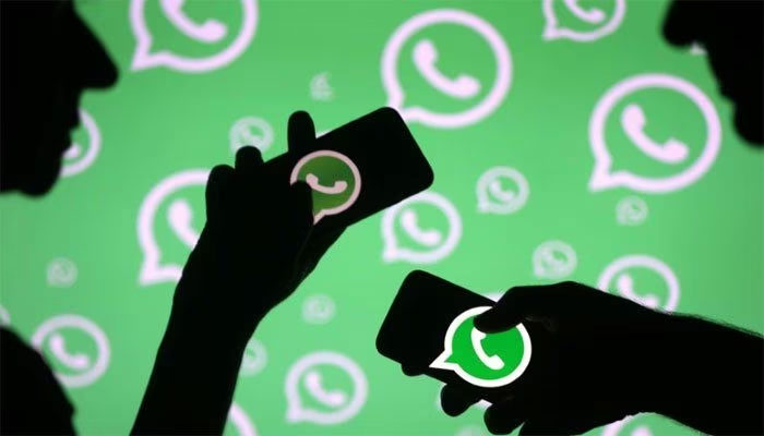 This representational picture shows two users holding smartphones with the WhatsApp logo displayed. — Khaleej Times/File